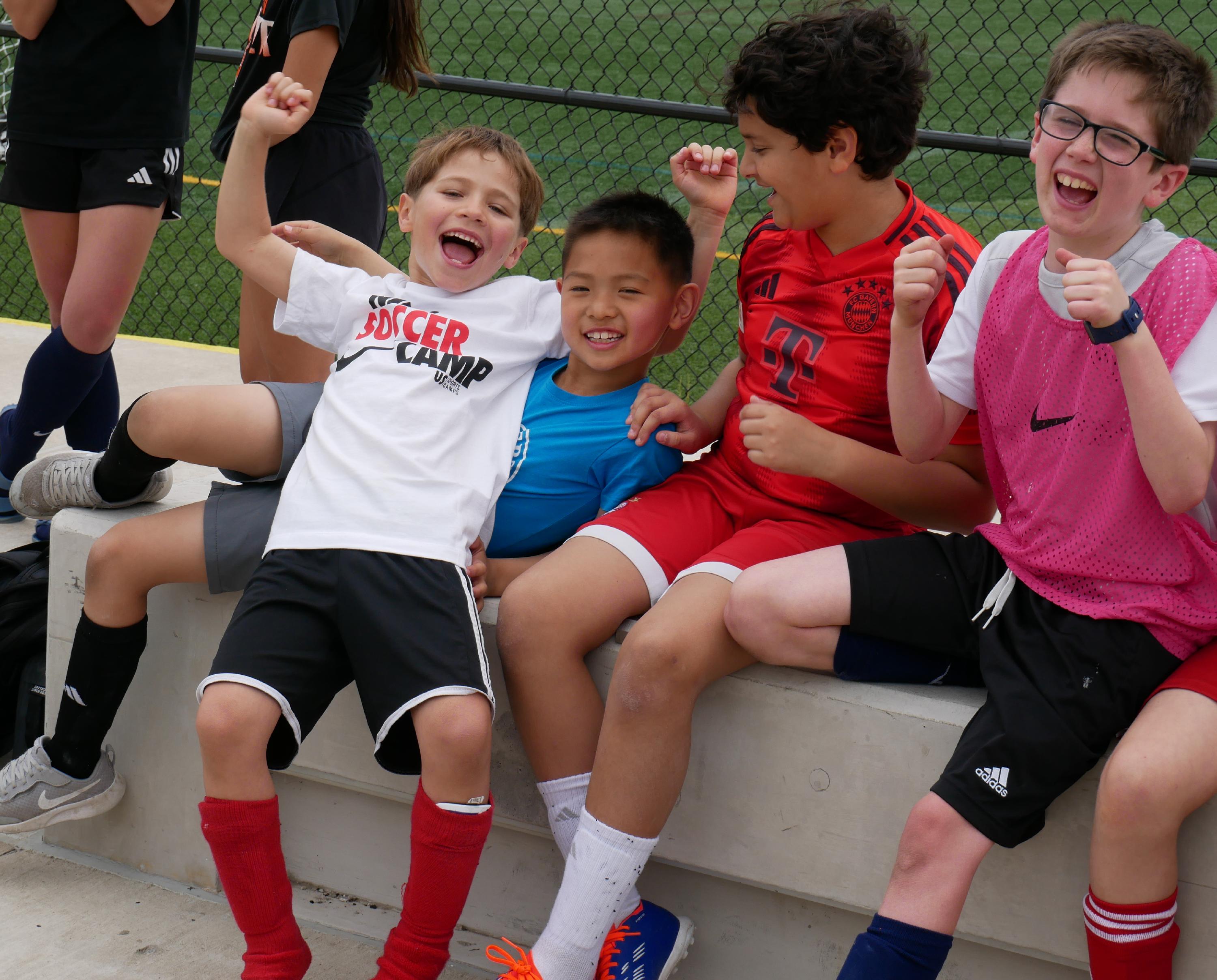 four young boys cheering